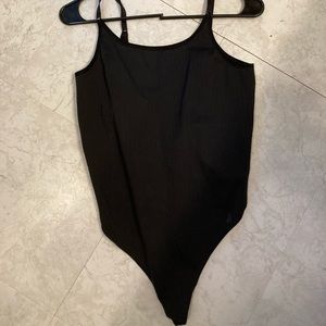 Black LULULEMON one piece body suit. Size 4. 
Tag missing.